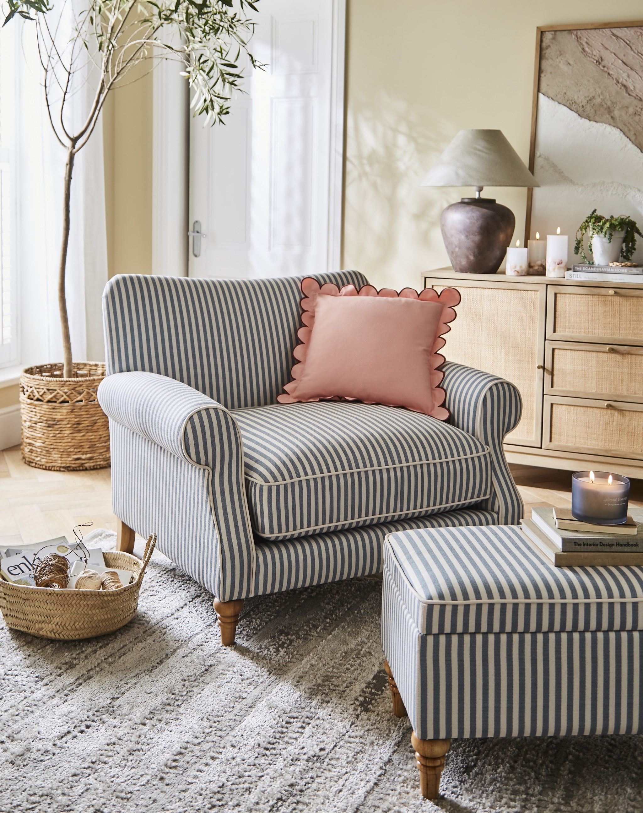 Living room with striped sofa and pink cushion