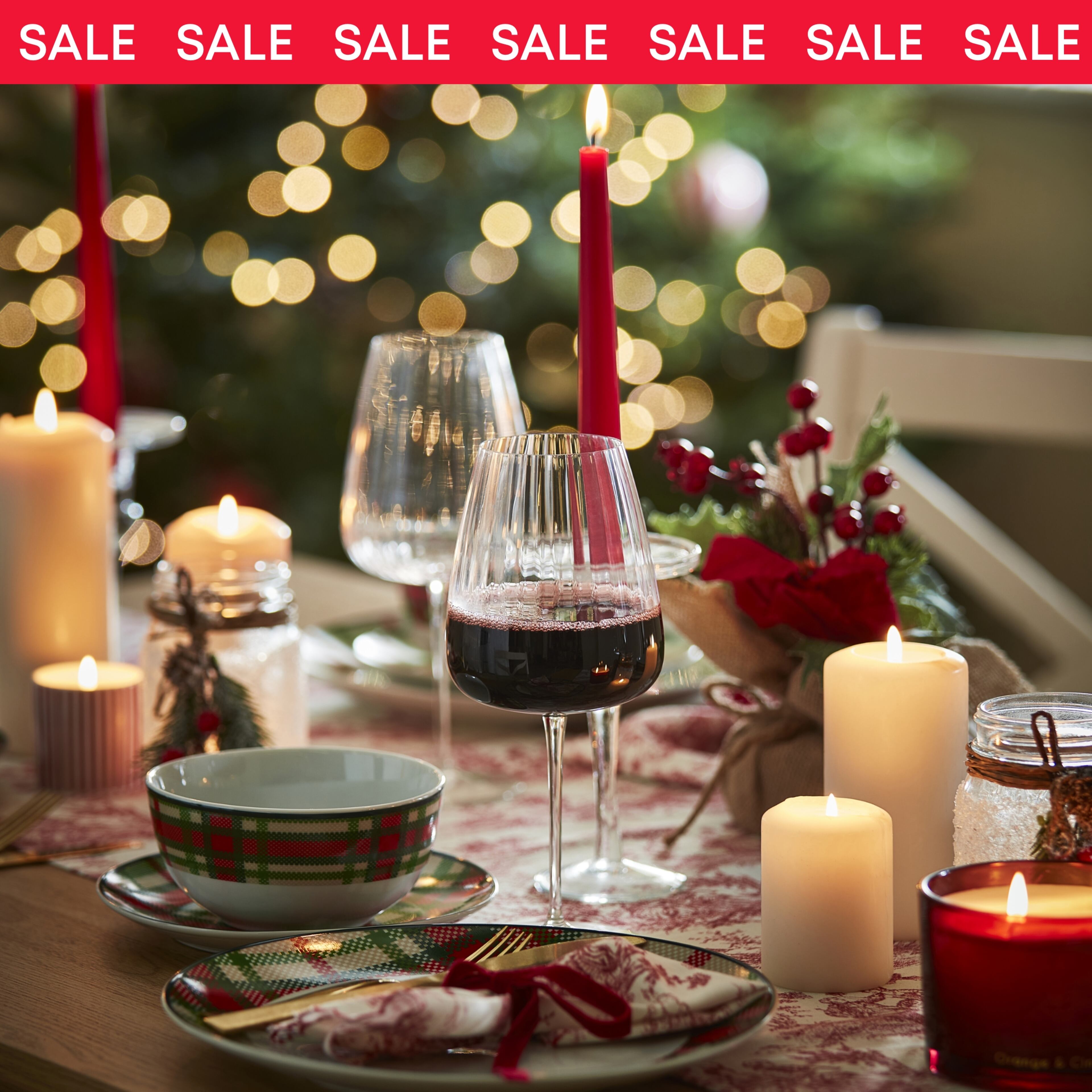 Elegant Christmas Table Setting With Candles, Wine Glasses, Festive Decor, And Cozy Holiday Atmosphere